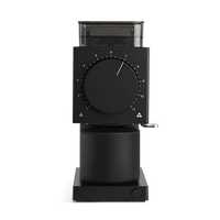 A sleek black manual coffee grinder with a large central dial, transparent bean hopper, and metal crank handle, shown on a clean white background.